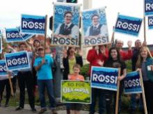 People waving signs for Marco Rossi to be elected mayor of Olympia, Washington